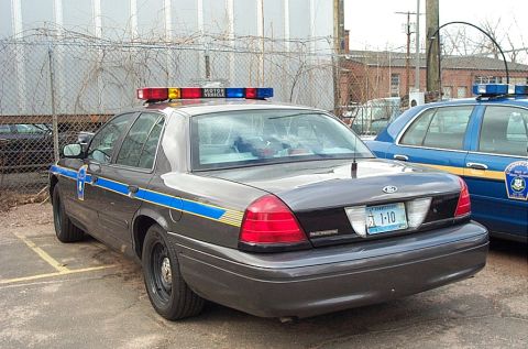 2001 Ford Crown Victoria - A 2001 Ford Crown Victoria police car is parked next to another police vehicle.