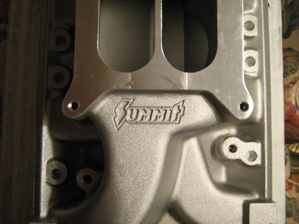 Close-up of a Summit logo cast into an aluminum intake manifold