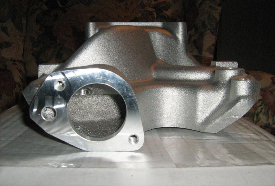 End view of an aluminum intake manifold showing thermostat housing flange