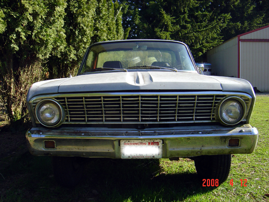 Front view of a vintage light-colored sedan with a Washington license plate.