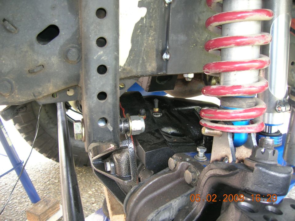 1996 Ford Bronco suspension with red coilover shock absorber.