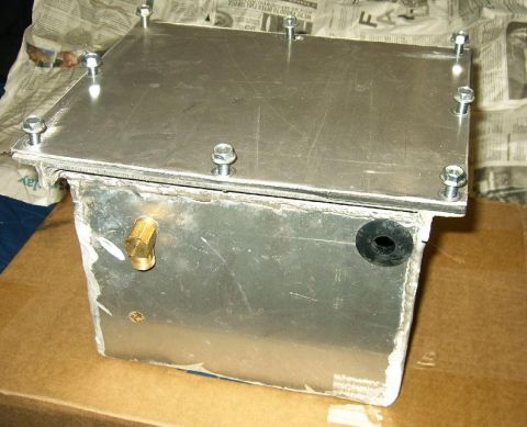 1992 Ford Probe - A custom-built aluminum tank with a bolted-on lid is shown, featuring a brass fitting and a rubber grommet on its side. The tank appears to…