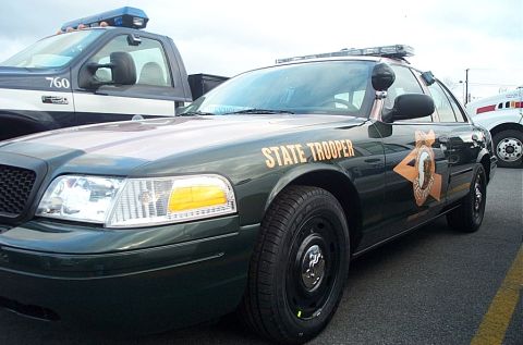 2001 Ford Crown Victoria - A State Trooper Crown Victoria is parked next to other vehicles in a lot.