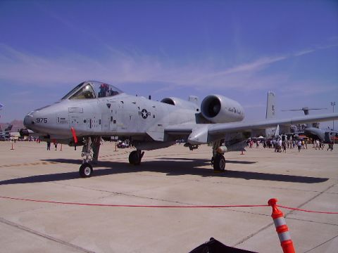 1990 Ford Bronco - A U.S. Air Force A-10 Thunderbolt II ground-attack aircraft is parked on an asphalt tarmac under a clear blue sky. The aircraft is gray wit…