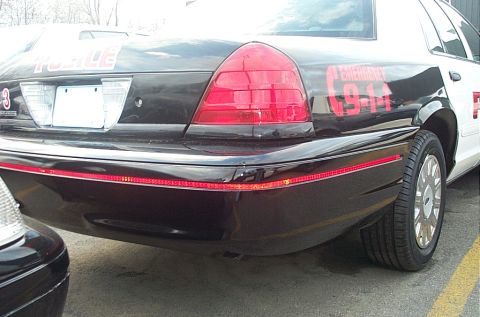 2001 Ford Crown Victoria - Rear view of a 2001 Ford Crown Victoria police car, showing emergency markings and lights.