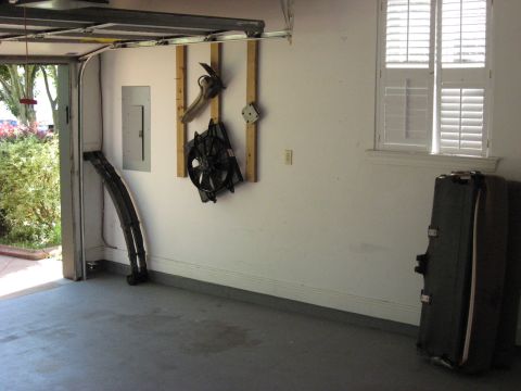 2006 Ford F-150 - A garage scene shows automotive parts hanging on the wall and leaning against the wall.