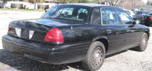 Black 2005 Ford Crown Victoria, rear passenger side view