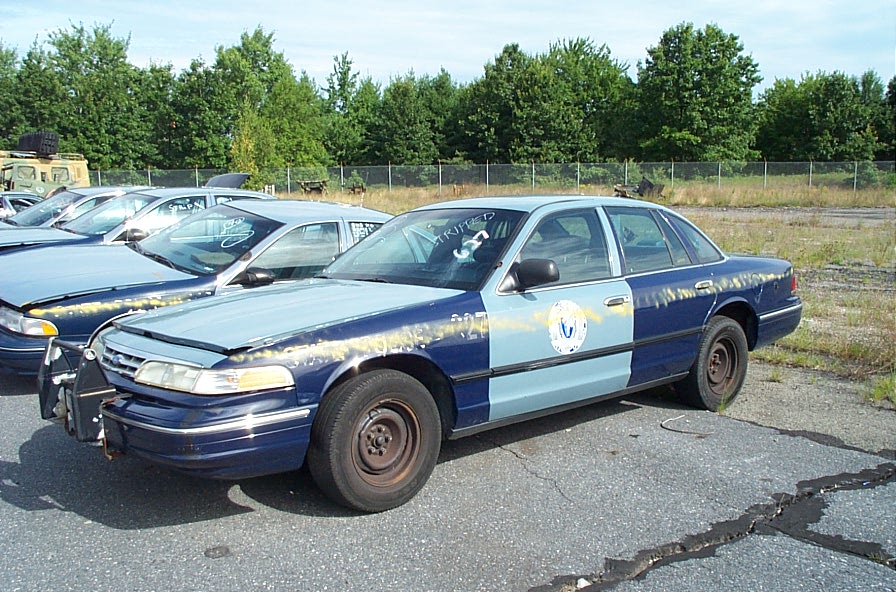 2001 Ford Crown Victoria, two-tone blue and light blue, dented hood, cracked windshield, parked outdoors