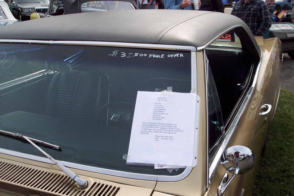 Gold 1967 coupe with black vinyl top, black interior, and a for sale sign on the windshield