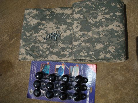 1995 Ford Bronco - Military camouflage fabric and tire chains are laid out on a floor.