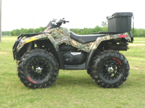 2008 Bombardier Outlander - This ATV is covered in camouflage and has a black storage box mounted on the rear rack.