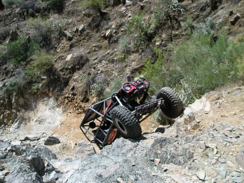 1986 Toyota Hilux - Custom off-road buggy navigates a challenging rocky terrain.