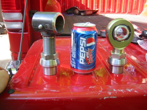 1995 Ford Bronco - Two metal rod ends and a can of Pepsi Wild Cherry are placed on the red bed of a truck.