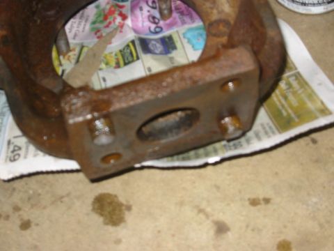 1995 Ford Bronco - A rusty exhaust manifold is shown, resting on newspaper with visible pricing information.
