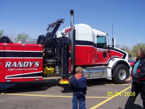 1972 Ford Ranchero - A tow truck with "Randy's High Country Towing" branding is parked outdoors on a sunny day.