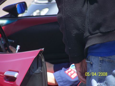 1972 Ford Ranchero - A person reaches into the interior of a red vehicle, with a date stamp of 05/04/2008 visible.