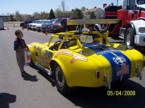 1972 Ford Ranchero - A custom-built yellow race car is parked outdoors, racing stripes and sponsor decals.
