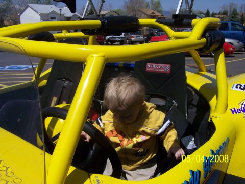 1972 Ford Ranchero - A young child sits in the driver's seat of a bright yellow go-kart, with a 'KIRKEY' racing seat visible.