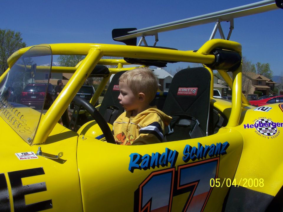 Kid in yellow racing buggy with 'Randy Schranz 17' on the side