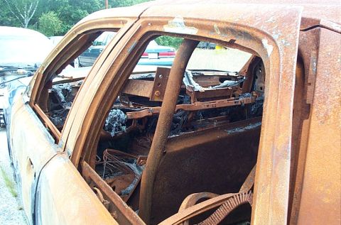 2001 Ford Crown Victoria - The interior of this vehicle is severely damaged, with melted components and extensive rust.