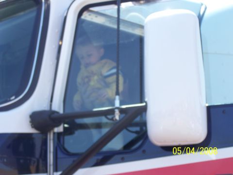 1972 Ford Ranchero - A baby is visible inside the cab of a large truck, seen through the side window.