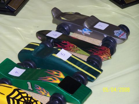 1972 Ford Ranchero - A collection of custom-built pinewood derby cars are displayed, ready for a race.