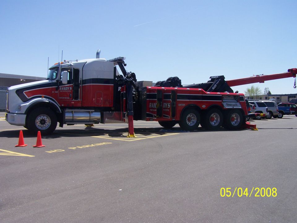 Red and white tow truck with 'Randy's' on the door