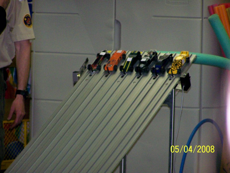 toy cars lined up on a ramp for a race