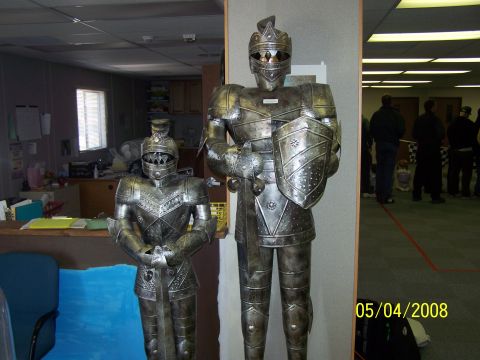 1972 Ford Ranchero - Two suits of armor are displayed in an office setting, with people visible in the background.