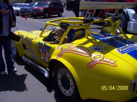 1972 Ford Ranchero - Yellow race car with roll cage and spoiler, child in driver's seat. Date stamp reads 05/04/2008.