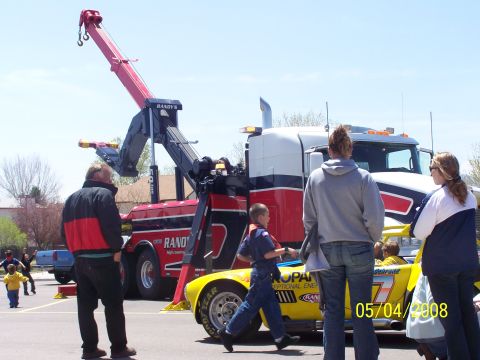 1972 Ford Ranchero - A tow truck is positioned next to a yellow race car with the date 05/04/2008 visible on the car.