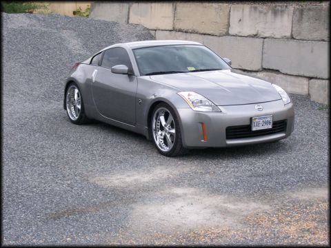 2003 Nissan 350Z - This silver 2003 Nissan 350Z coupe is viewed from a three-quarter front angle, parked on a gravel surface.