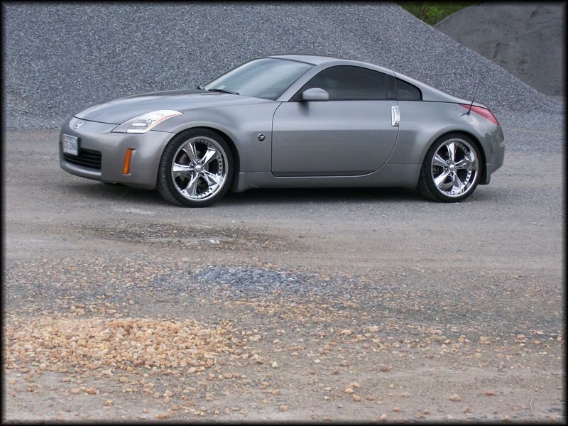 Silver 2003 Nissan 350Z coupe with chrome wheels parked on a gravel road