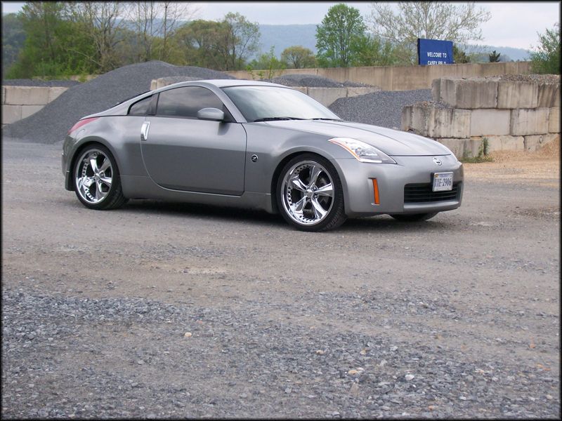 Silver 2003 Nissan 350Z with chrome wheels parked outdoors