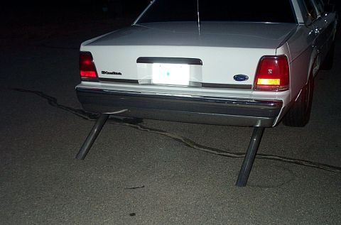 2001 Ford Crown Victoria - The rear of a white 2001 Ford Crown Victoria is shown with a custom dual exhaust system.