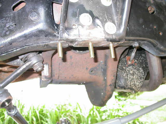 I decided to make a bolt on upper trac bar mount instead of welding one on.  You can see here where I replaced three rivets with bolts.