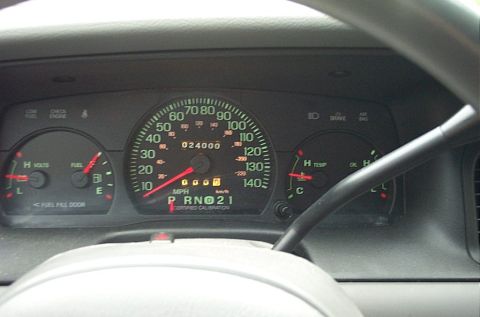 2001 Ford Crown Victoria - The interior view of a 2001 Ford Crown Victoria's dashboard displays the speedometer, fuel gauge, and temperature gauge.