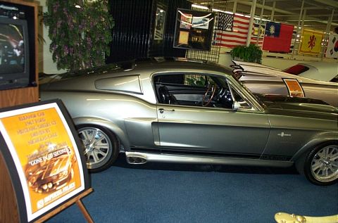 2001 Ford Crown Victoria - A classic Shelby GT500 is displayed indoors, with a sign and another vehicle visible.