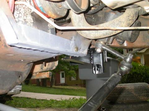 1990 Ford Bronco - Close-up of vehicle undercarriage components, including suspension and steering parts, with a Supermotors watermark.