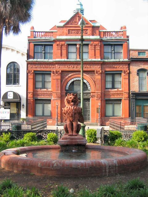 1985 Ford LTD Crown Victoria - Photo of the red-brick Savannah Cotton Exchange building with a lion statue fountain in the foreground.