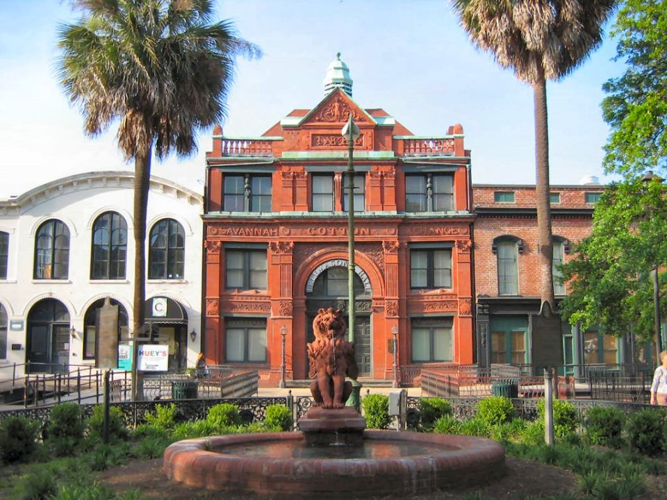 Savannah, GA historic buildings with a fountain and palm trees
