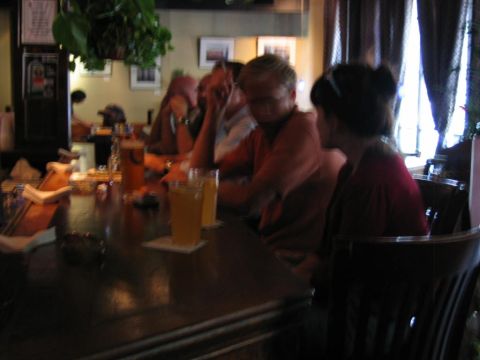 1985 Ford LTD Crown Victoria - Patrons enjoy beverages at a dimly lit bar counter.