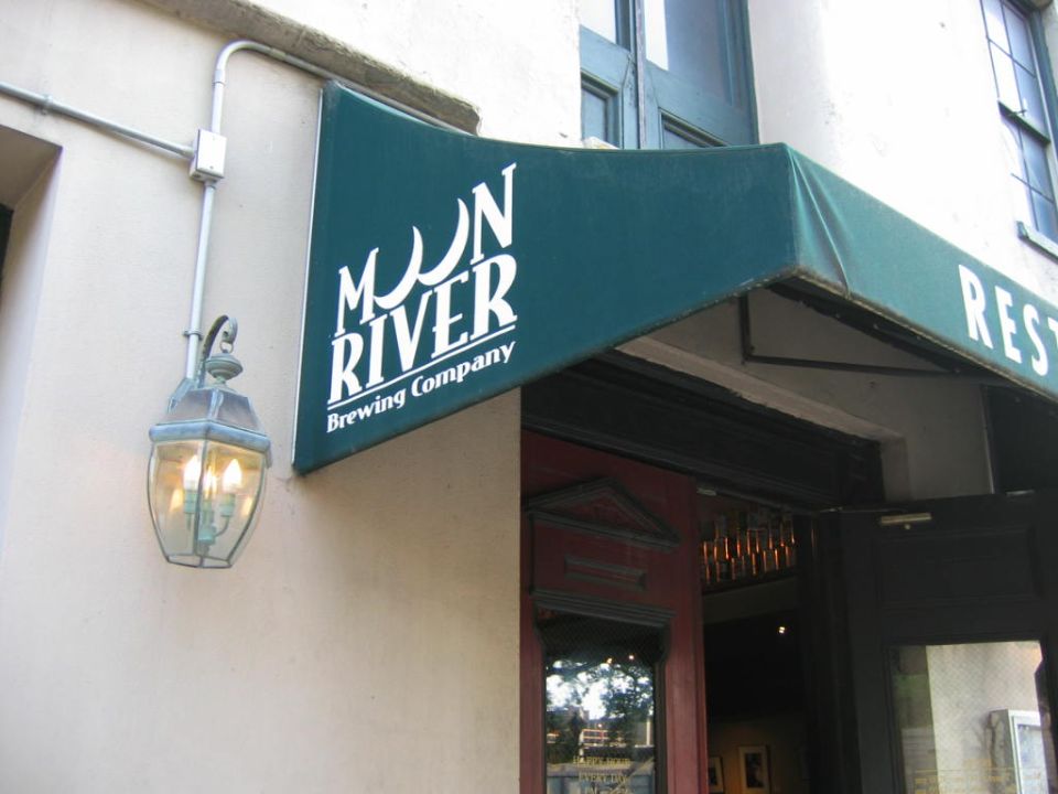 Storefront awning for Moon River Brewing Company with a lantern on the wall