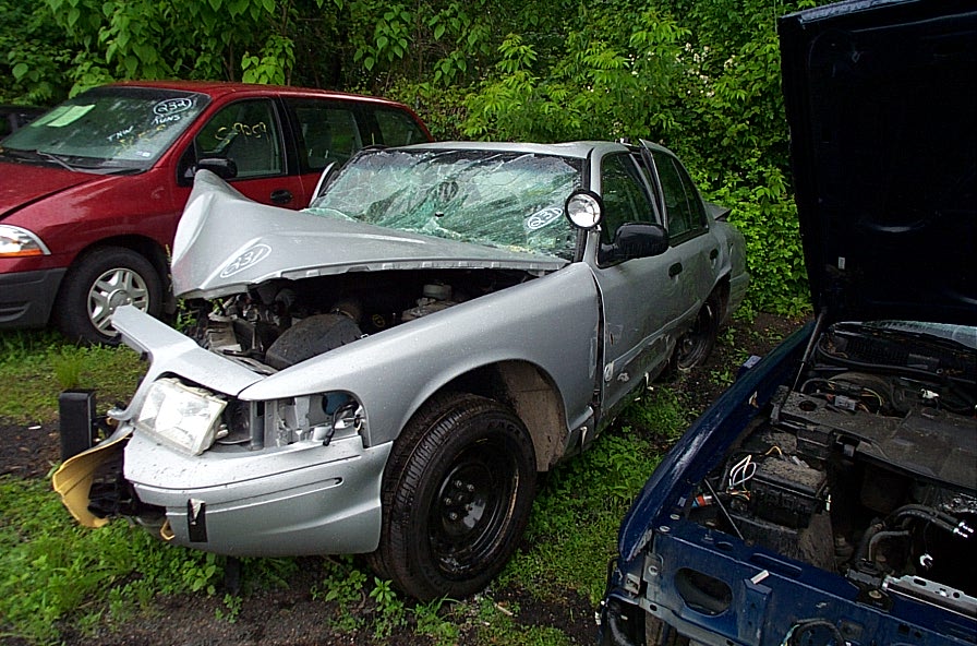 Silver 2001 Ford Crown Victoria, 3q front view, damaged front end, cracked windshield