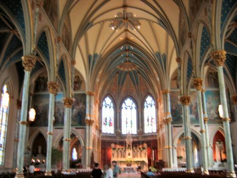 1985 Ford LTD Crown Victoria - View of the nave and altar inside a large cathedral, with ornate architectural details.