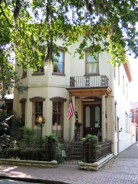 1985 Ford LTD Crown Victoria - A historic house in Savannah, GA, features a balcony and an American flag near the entrance.