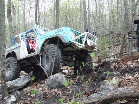 1969 Ford Bronco - Modified 1969 Ford Bronco tackling a challenging rocky terrain during an off-road event.