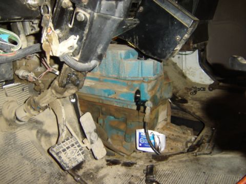 1992 Ford Bronco - Interior view of a vehicle's engine compartment and driver's footwell, showing pedals and exposed mechanical components.