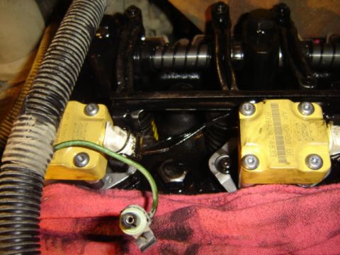 1992 Ford Bronco - Close-up view of a yellow engine component with visible part numbers and wiring.