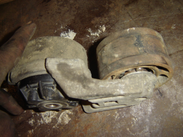 dirty engine mount with metal bracket and rubber isolators